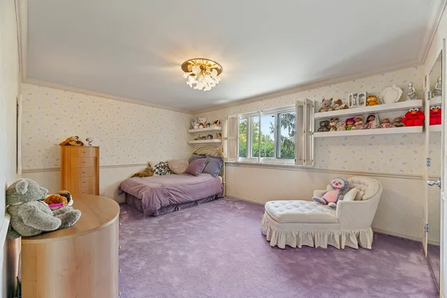 a living room with furniture a chandelier and a large window