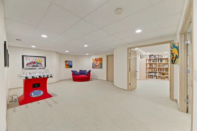 a living room with furniture gym equipment and a ceiling fan