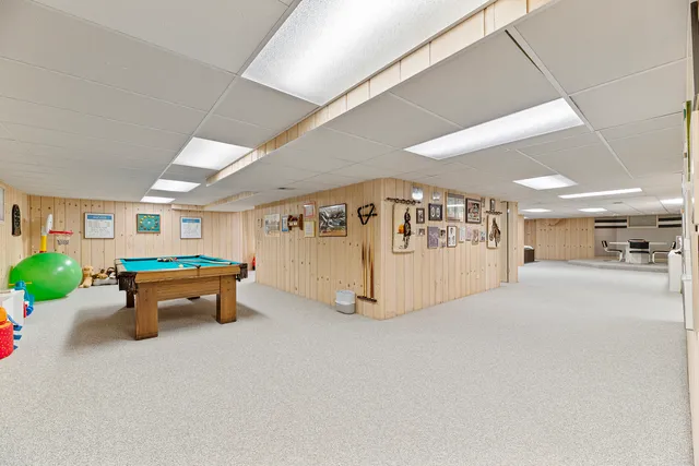 a bathroom with a shower sink vanity mirror and toilet