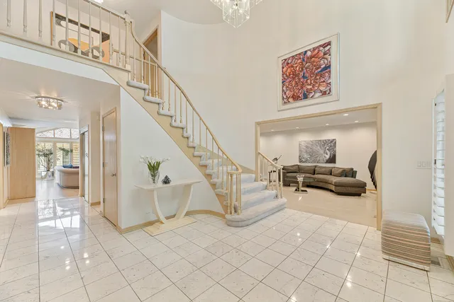 a living room with fireplace furniture and a large window