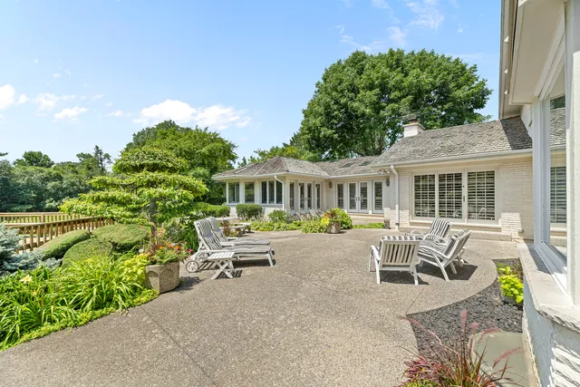 a view of a patio with table and chairs and potted plants