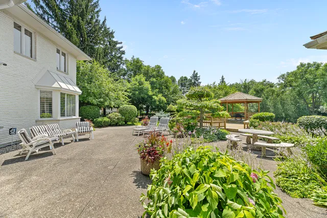 an aerial view of a house with swimming pool and garden