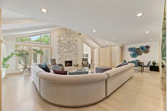 a living room with fireplace furniture and a chandelier