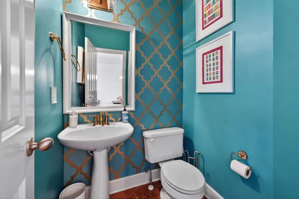 a bathroom with a toilet sink and mirror