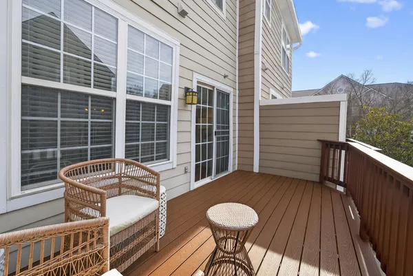 a view of balcony with a couple of chairs