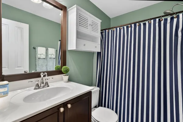 a bathroom with a sink a toilet and mirror