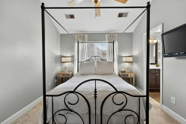 a bedroom with a bed and a chandelier