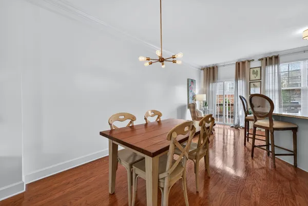 a view of a dining room with furniture and wooden floor