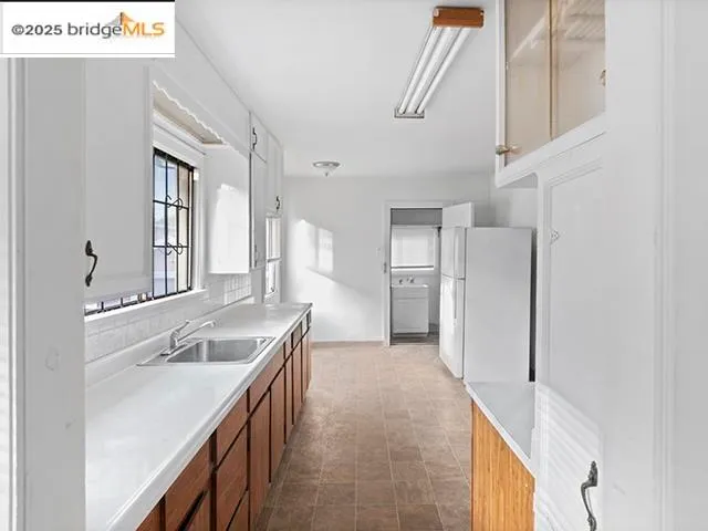 a bathroom with a granite countertop sink a mirror and a shower