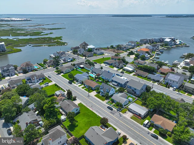an aerial view of a houses with a lake view