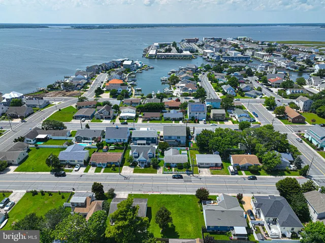 an aerial view of residential houses with outdoor space and swimming pool