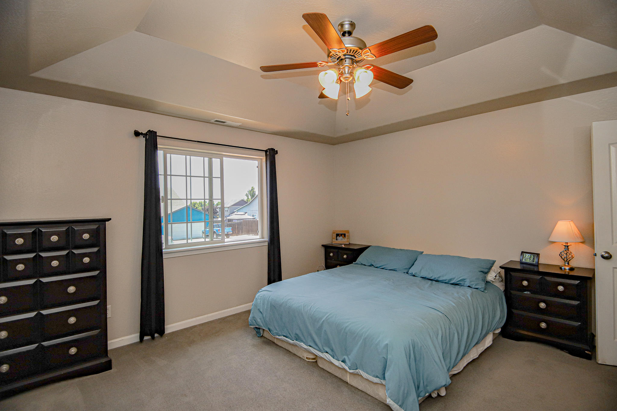 623 Barton Road Eagle Point, OR 97524 - Photo 13 of 28 a bedroom with a bed and a chandelier