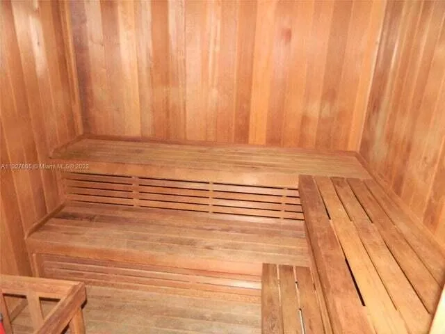 a view of a room with wooden floor and curtain