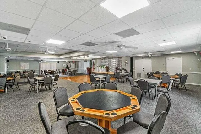 a dining room with wooden floor table and chairs