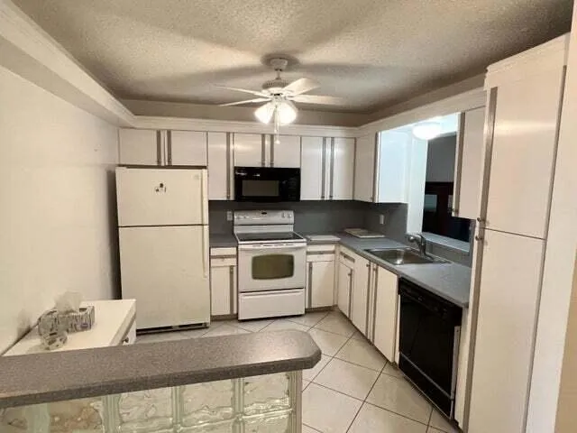 a kitchen with a sink appliances and cabinets