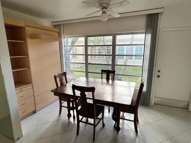 a view of a dining room with furniture and a window