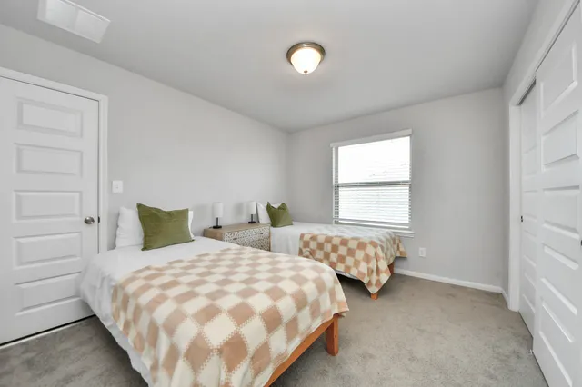 a bedroom with a bed and window