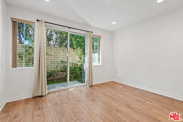 a view of wooden floor and windows in a room
