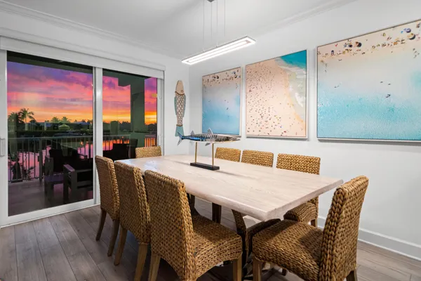 a living room with furniture kitchen view and a large window
