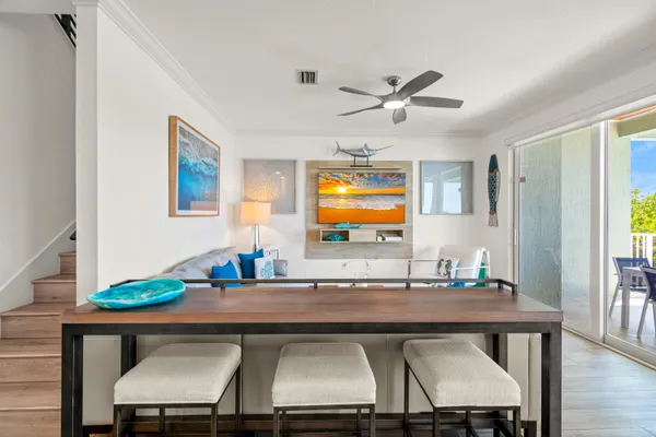 a dining room with furniture and wooden floor