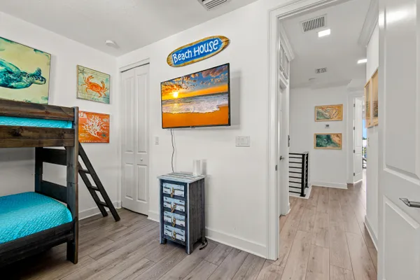 a bedroom with a bed and a flat screen tv