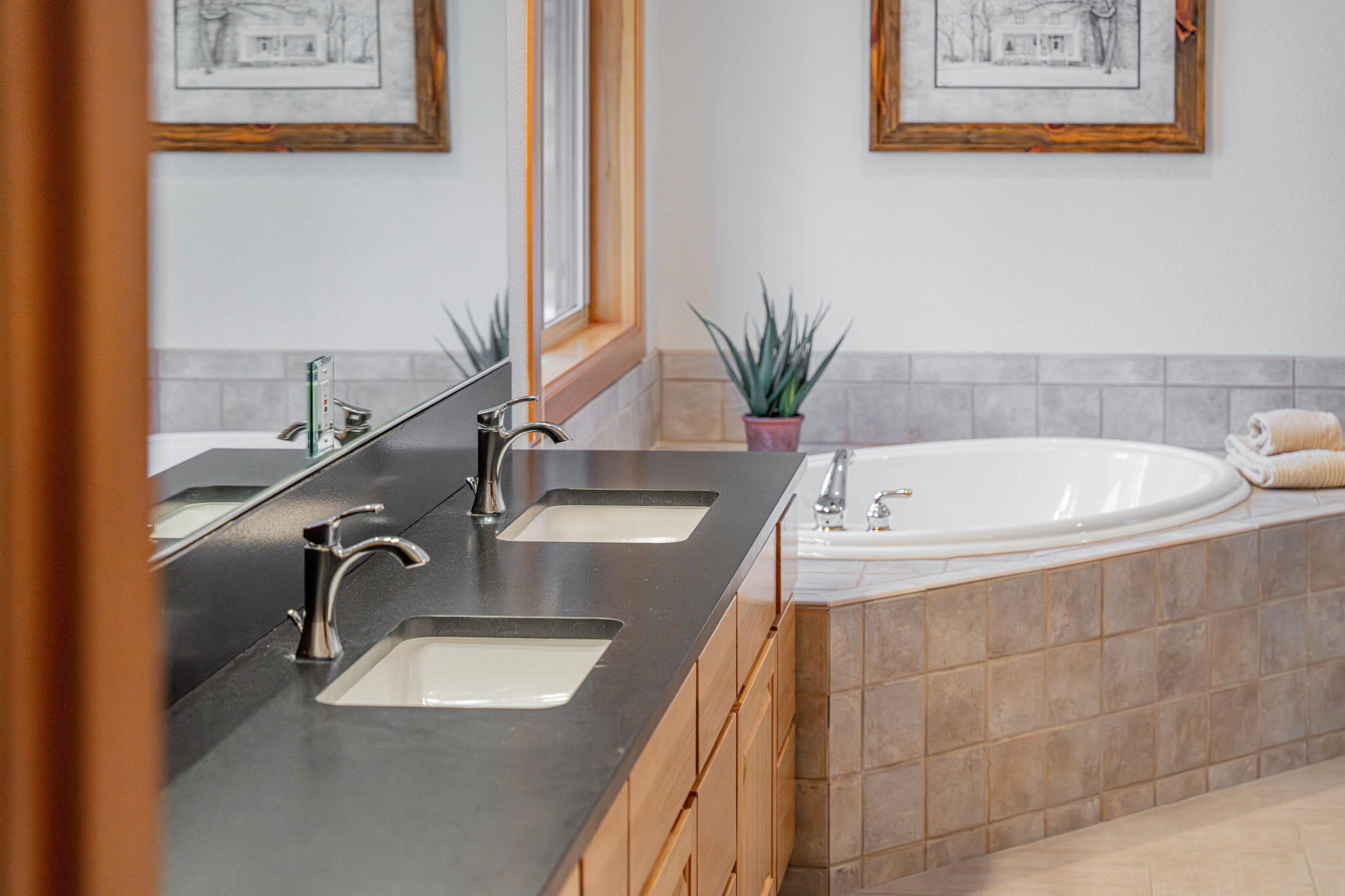 17948 Shadow Lane, Unit 7 Sunriver, OR 97707 - Photo 44 of 92 a bathroom with a granite countertop sink a mirror and a bathtub