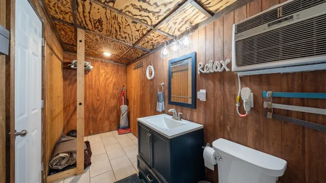 a bathroom with a sink a toilet a mirror and shower