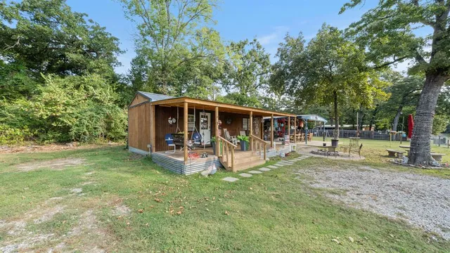 a view of a house with backyard and sitting area