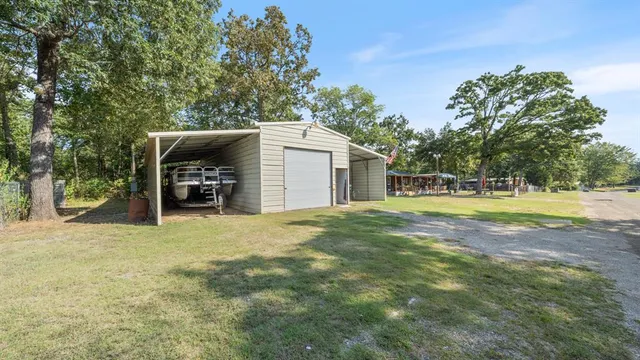 a view of a house with a yard and a garage