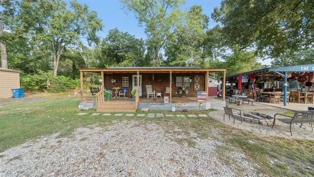 a view of a house with backyard and sitting area