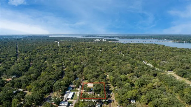 an aerial view of a houses with a yard