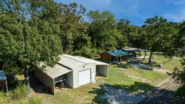 an aerial view of a house with yard swimming pool and outdoor seating