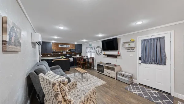 a living room with furniture and a flat screen tv