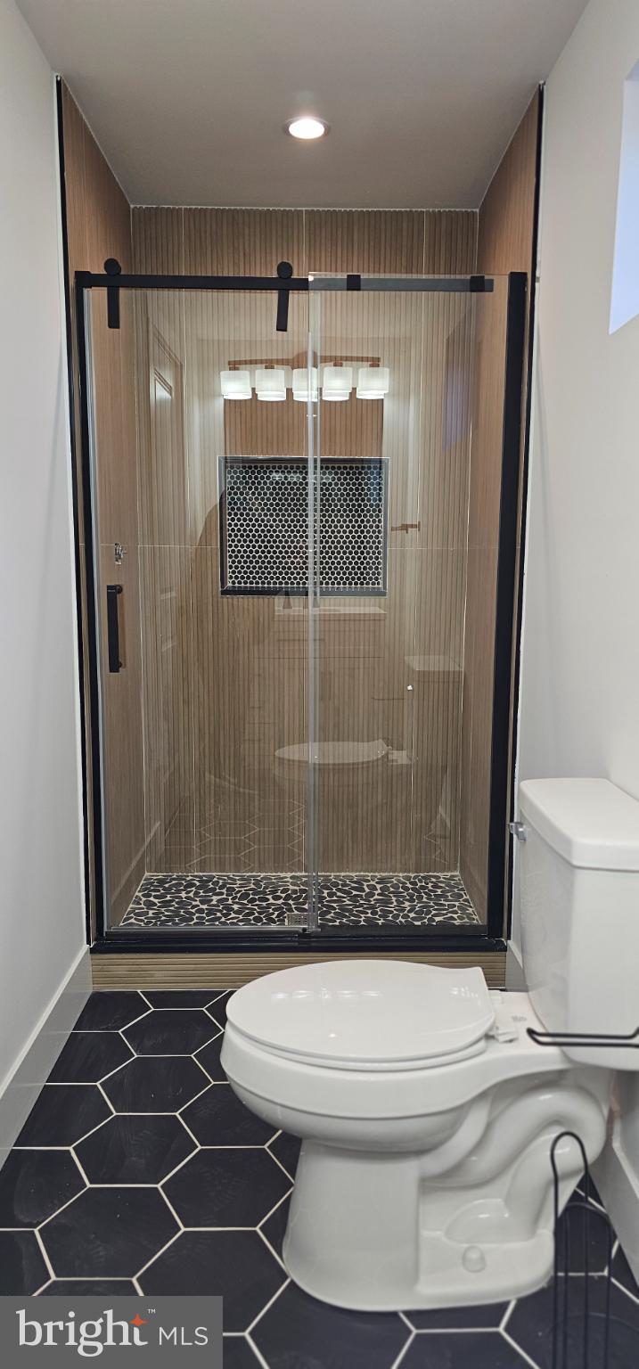 1427 Ocean Pleasantville, NJ 08232 - Photo 11 of 27 a bathroom with a toilet and a shower