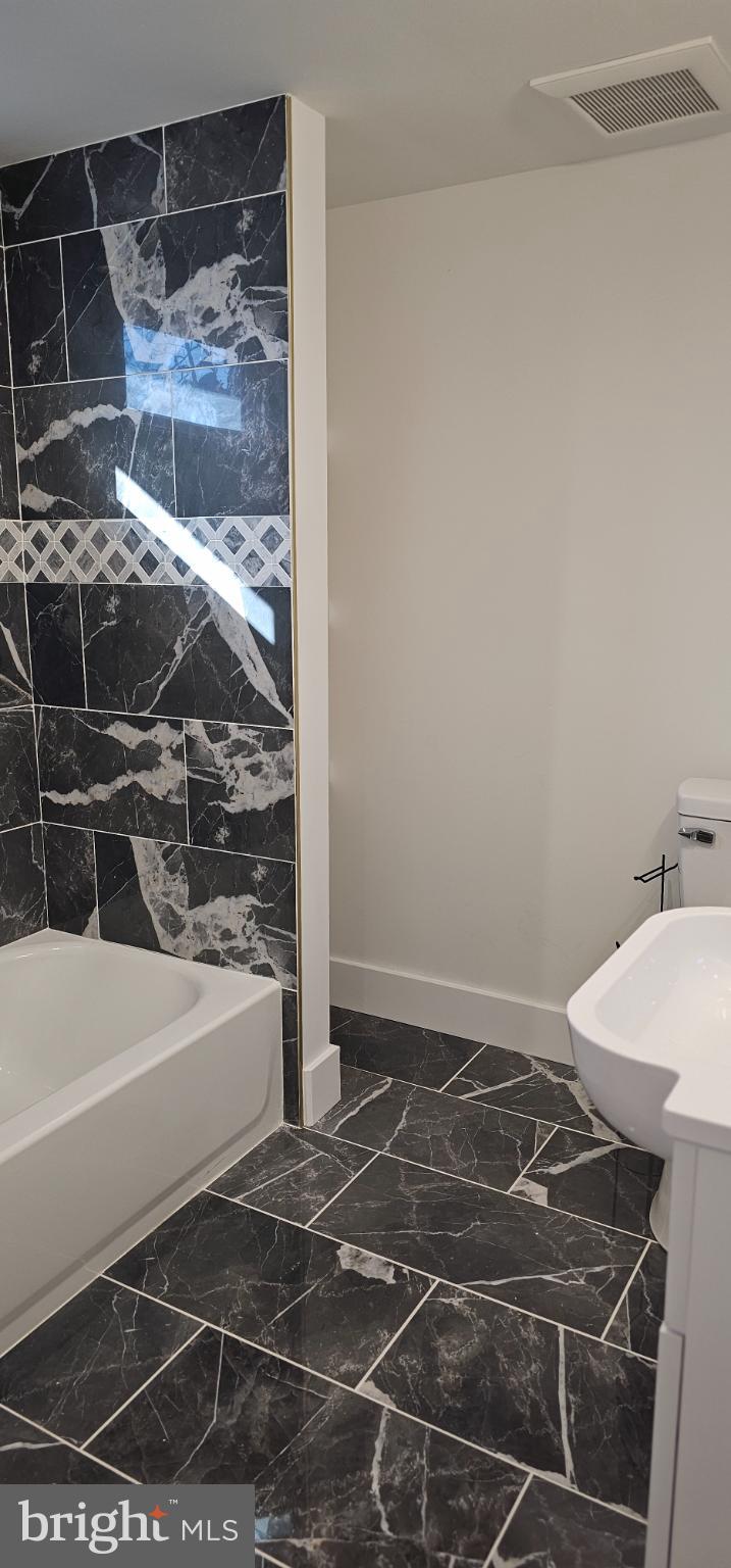 1427 Ocean Pleasantville, NJ 08232 - Photo 20 of 27 a bathroom with a sink and a mirror