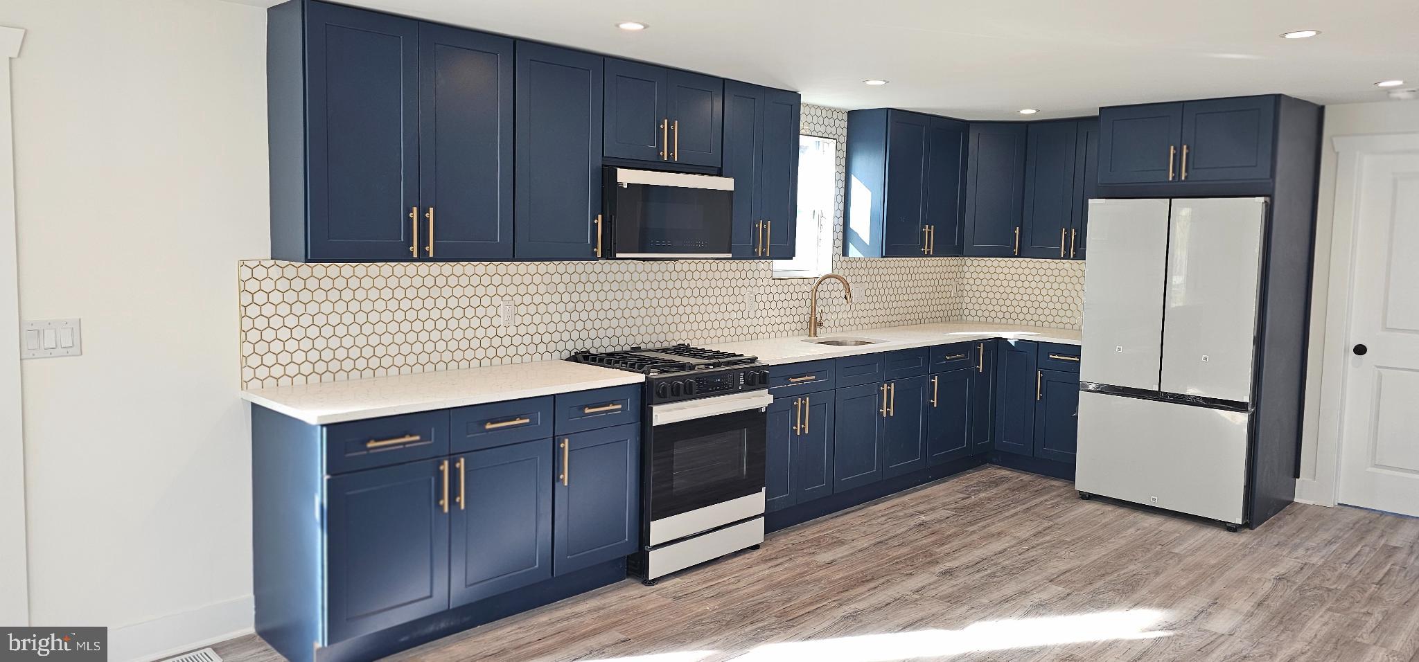 1427 Ocean Pleasantville, NJ 08232 - Photo 5 of 27 a kitchen with stainless steel appliances granite countertop a refrigerator a stove a sink and a microwave