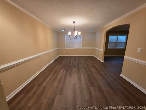 a view of wooden floor and a chandelier in a room