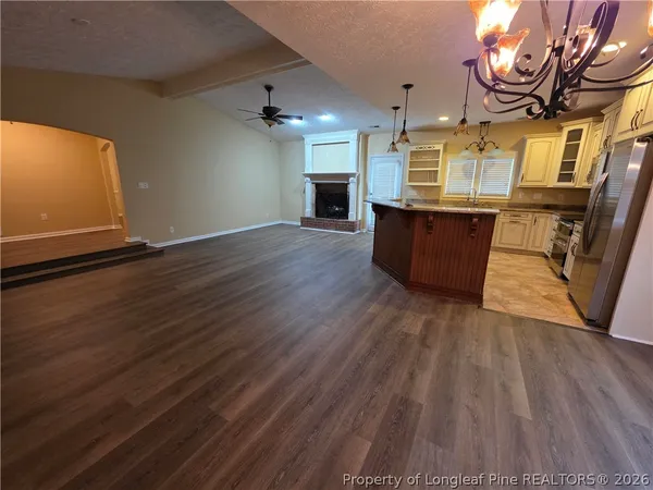 an empty room with wooden floor and entrance