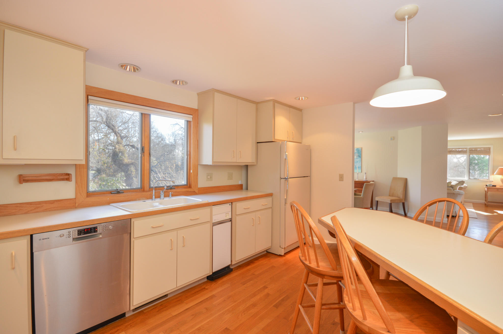 70 Indian Ridge Road Falmouth, MA 02540 - Photo 22 of 38 a large kitchen with stainless steel appliances a large window and a chandelier