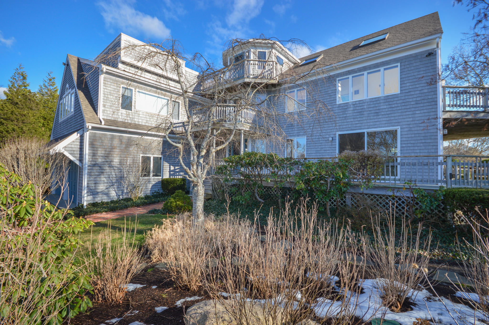 70 Indian Ridge Road Falmouth, MA 02540 - Photo 3 of 38 a view of a brick building next to a yard