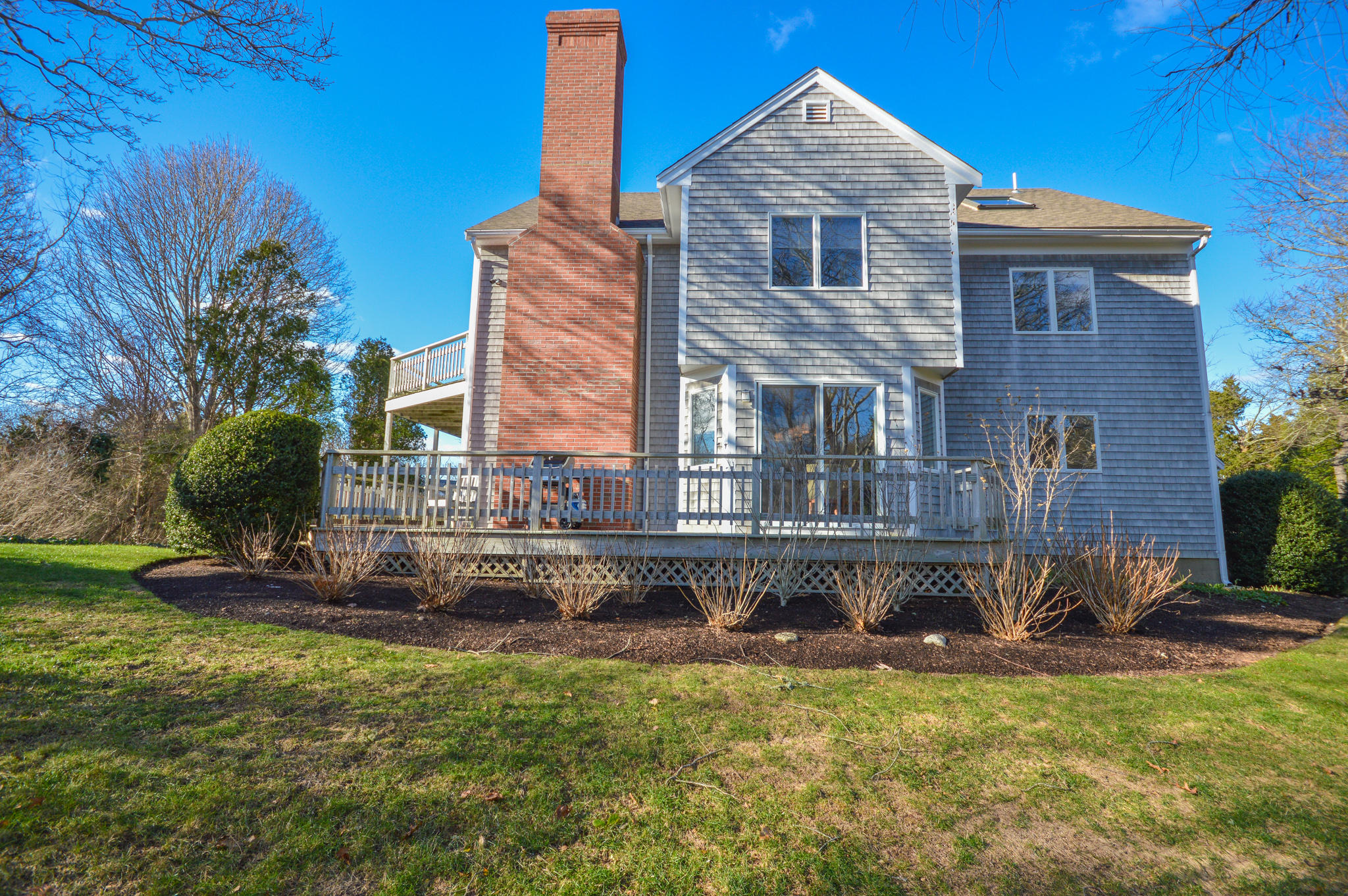 70 Indian Ridge Road Falmouth, MA 02540 - Photo 8 of 38 a front view of a house with a yard table and chairs