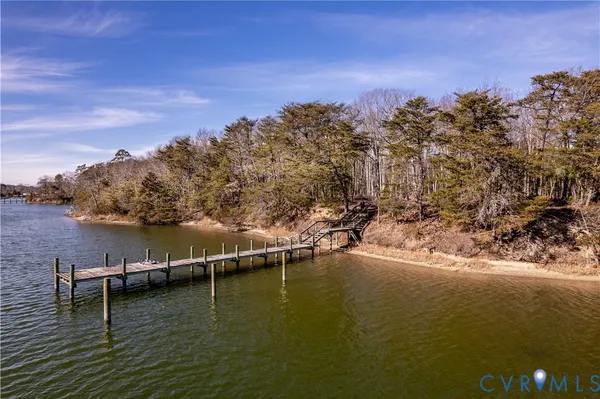 a view of a lake with boats and trees in the background