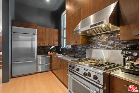 a vase of flowers sitting on a table with a potted plant