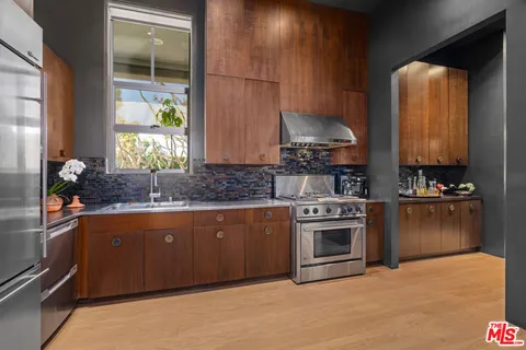 a living room with furniture a flat screen tv and floor to ceiling window