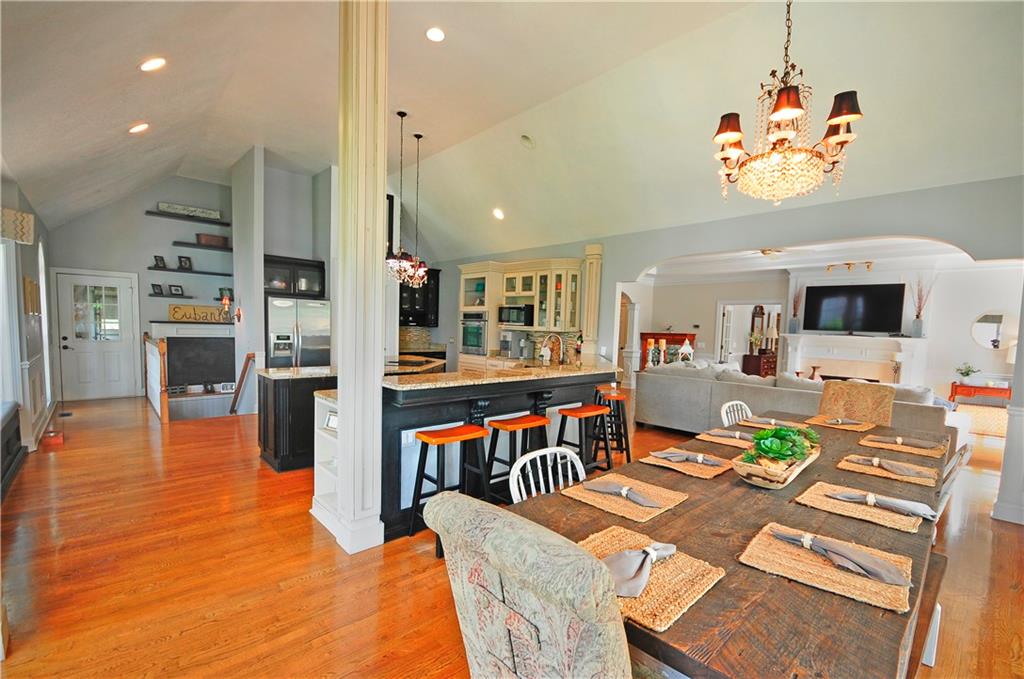 10121 Lakeview Parkway Villa Rica, GA 30180 - Photo 14 of 55 a dining room with furniture a kitchen view and large windows