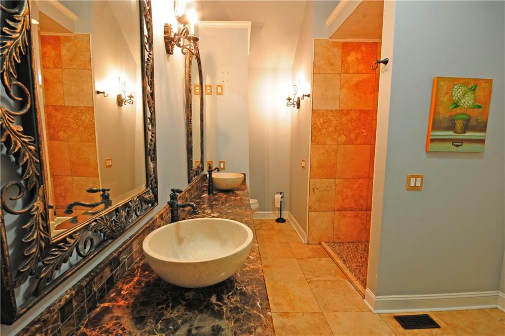 10121 Lakeview Parkway Villa Rica, GA 30180 - Photo 24 of 55 a bathroom with a sink a toilet and shower