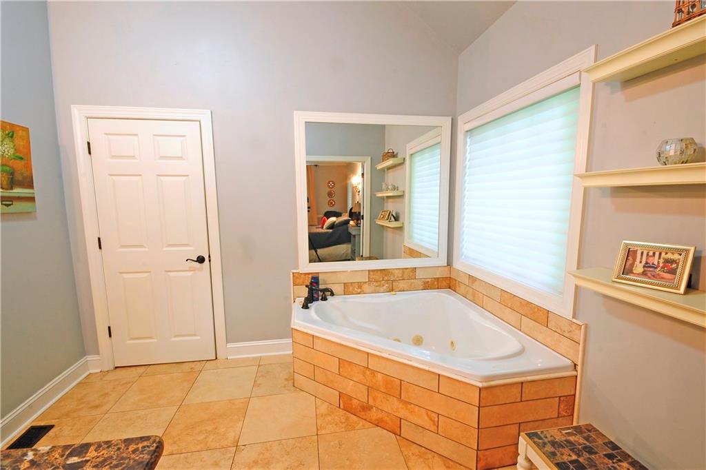 10121 Lakeview Parkway Villa Rica, GA 30180 - Photo 26 of 55 a bathroom with a tub and shower