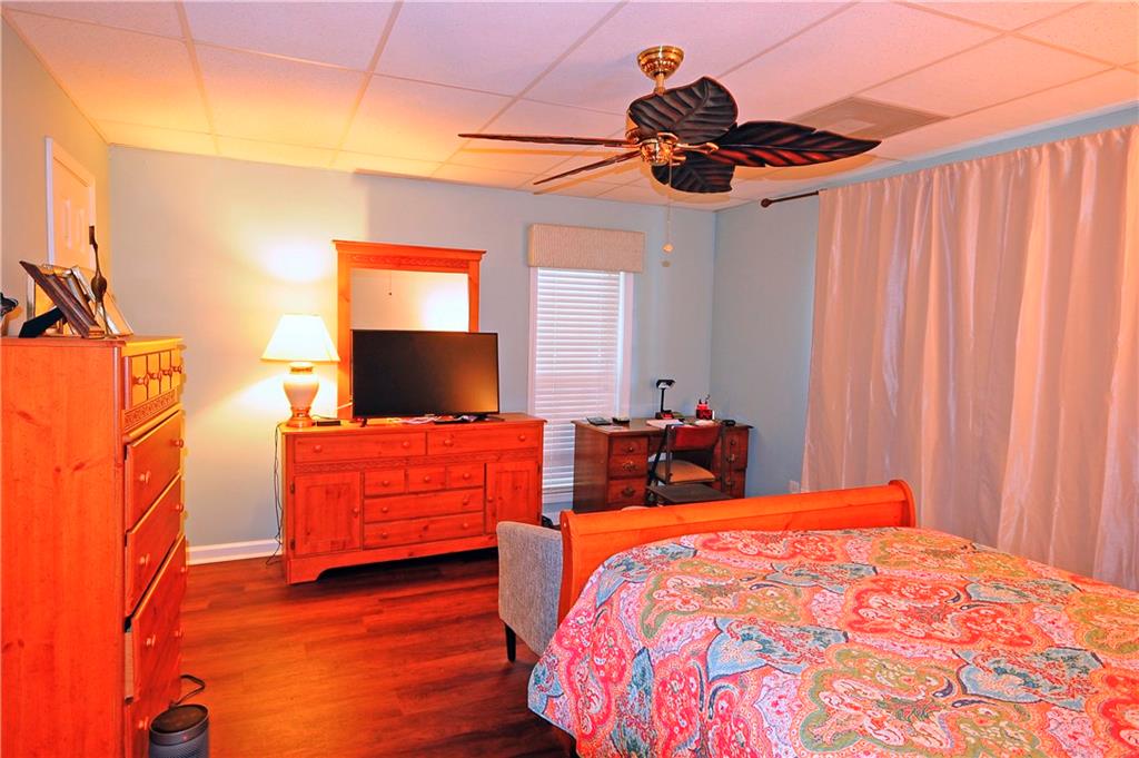 10121 Lakeview Parkway Villa Rica, GA 30180 - Photo 30 of 55 a bedroom with a bed and a chandelier