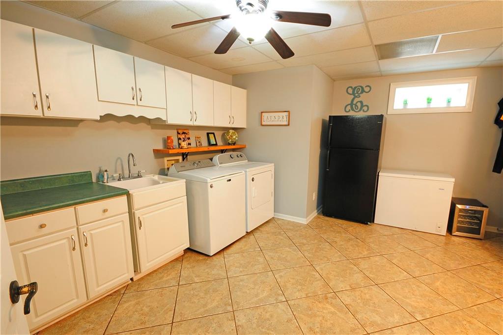 10121 Lakeview Parkway Villa Rica, GA 30180 - Photo 34 of 55 a kitchen with stainless steel appliances a stove a refrigerator a sink and white cabinets