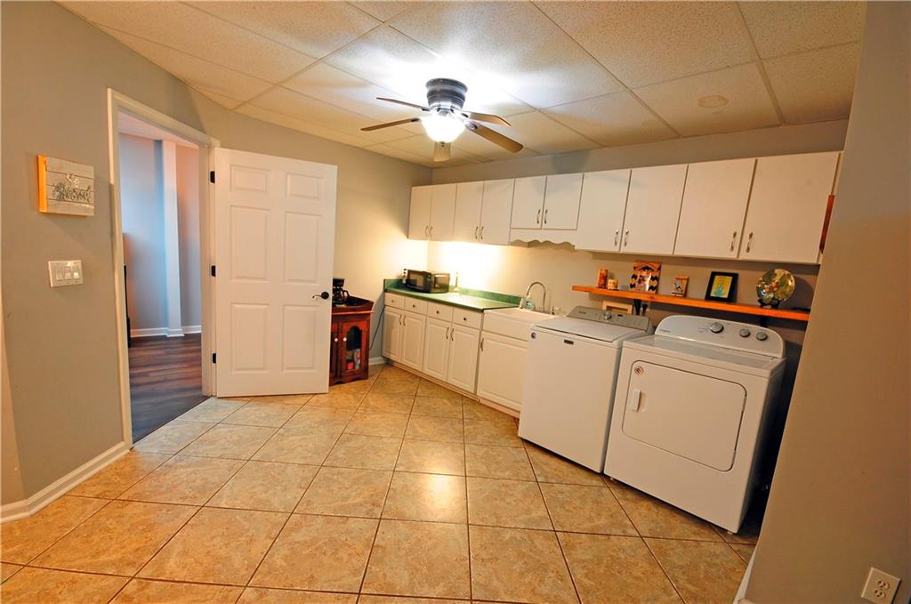10121 Lakeview Parkway Villa Rica, GA 30180 - Photo 35 of 55 a kitchen with cabinets and white appliances